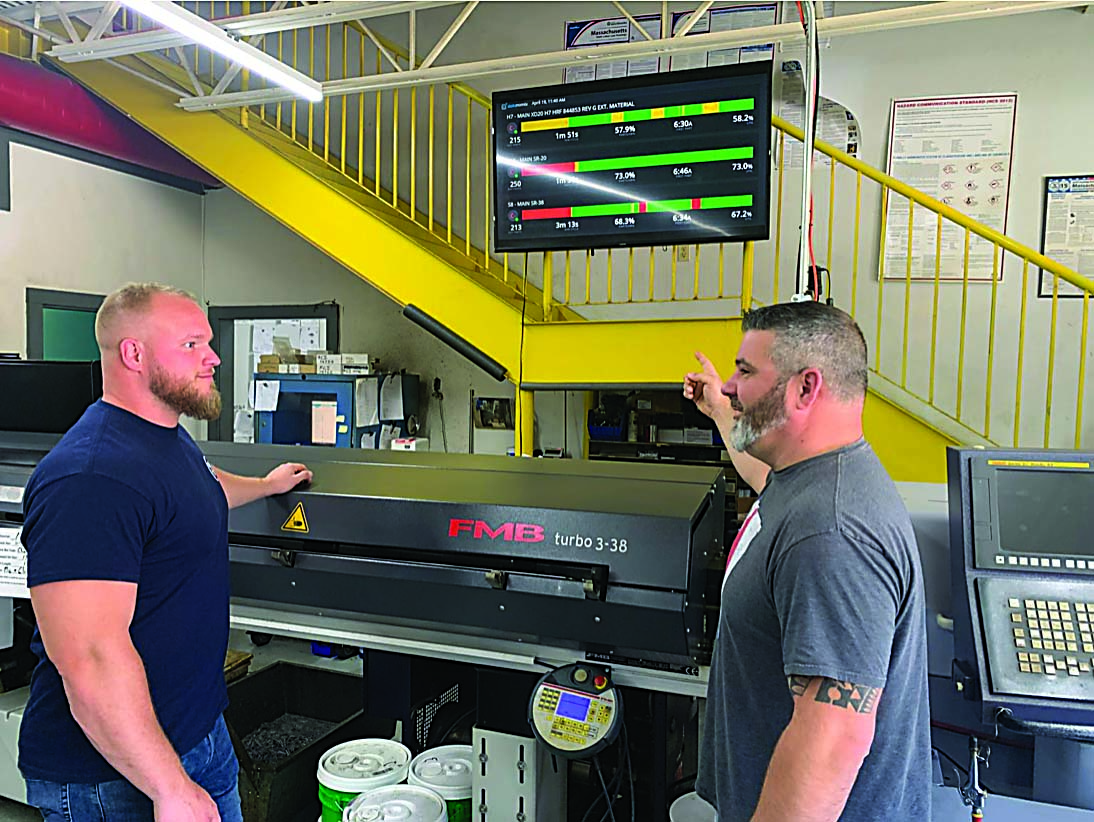  During their daily meeting, Tom Vinal (left), operations manager at DPC, and Matt Dipietro (right), president and owner of DPC, discuss factory plans involving Datanomix.