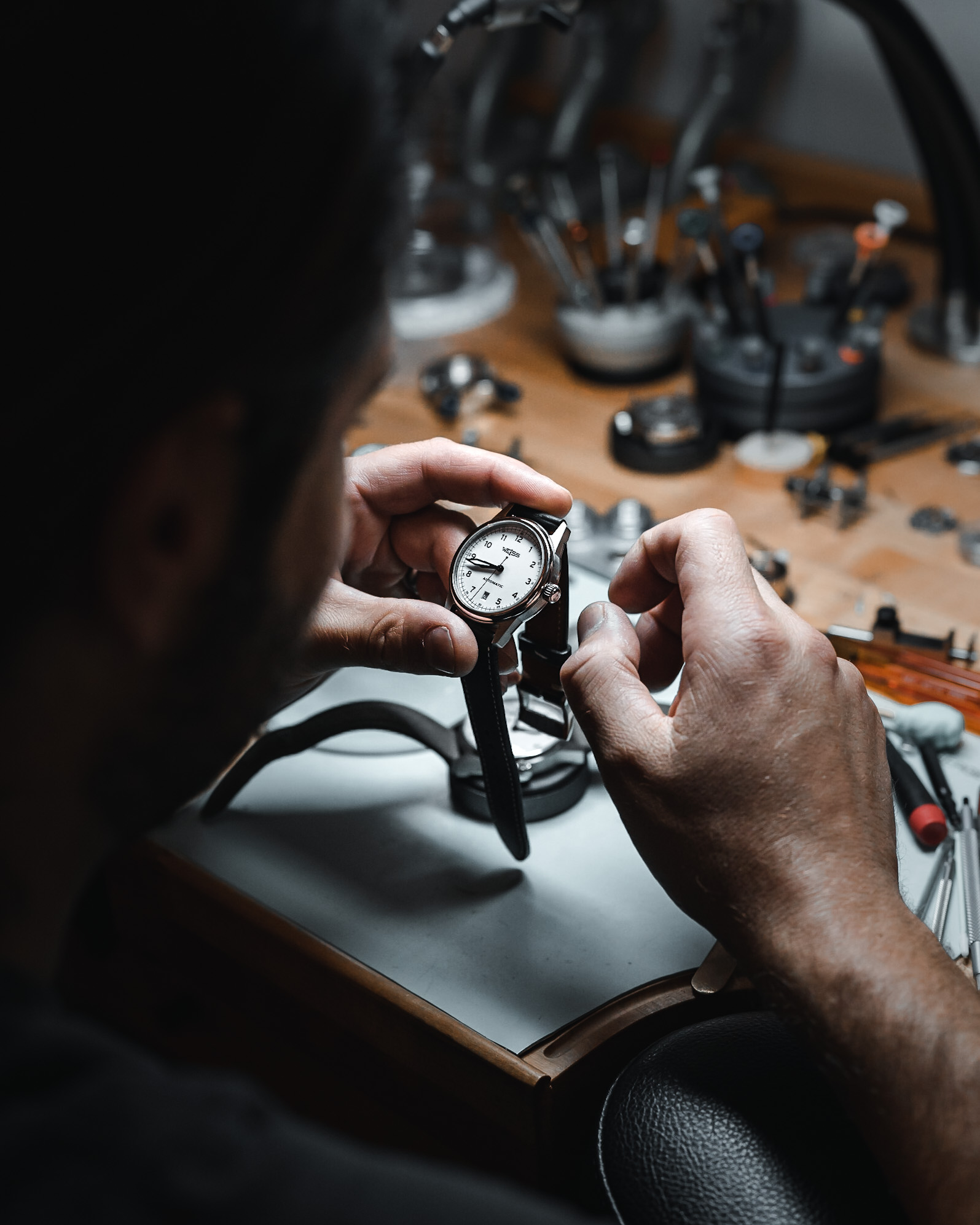 Cameron Weiss examines one of the heirloom-quality watches his company produces.