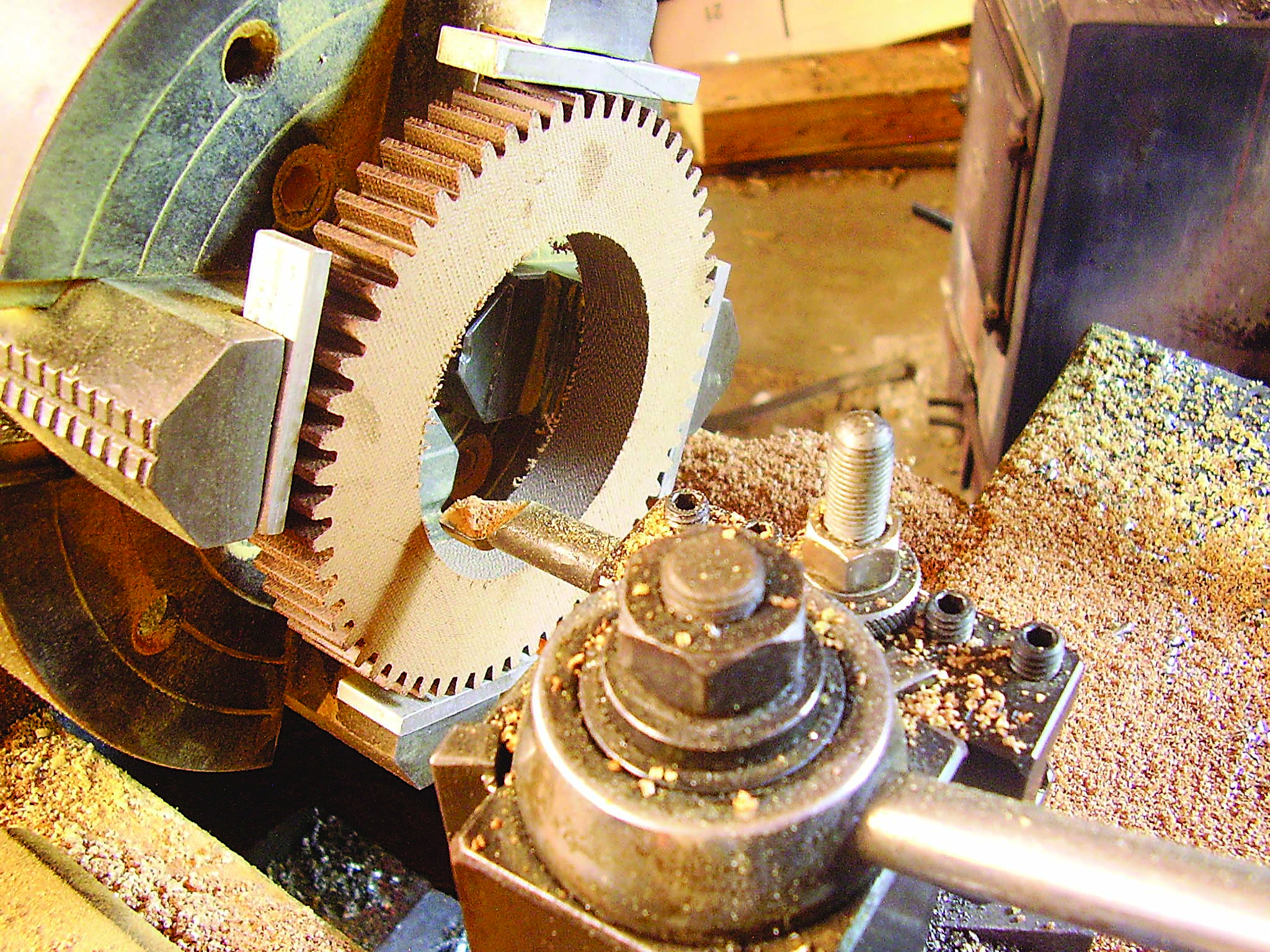 Pieces of aluminum stock are placed between the chuck jaws and the gear teeth.