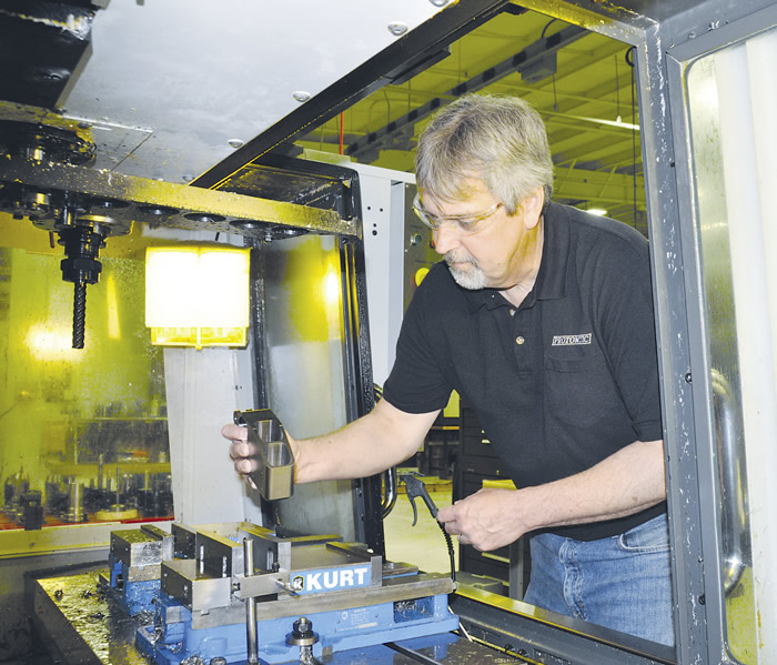 Les Smith, Protomatic’s senior machinist, loads a rocket-engine component made of Inconel 718 into a Mazak Quick Turn Nexus 200-II M. Image courtesy Protomatic.