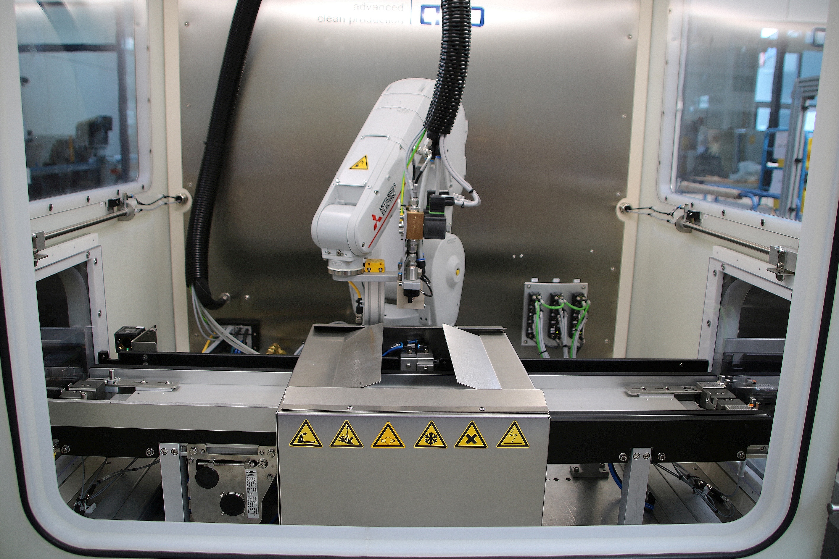 Workpiece carriers are loaded with around 150 parts are fed into and out of cleaning cabinets.