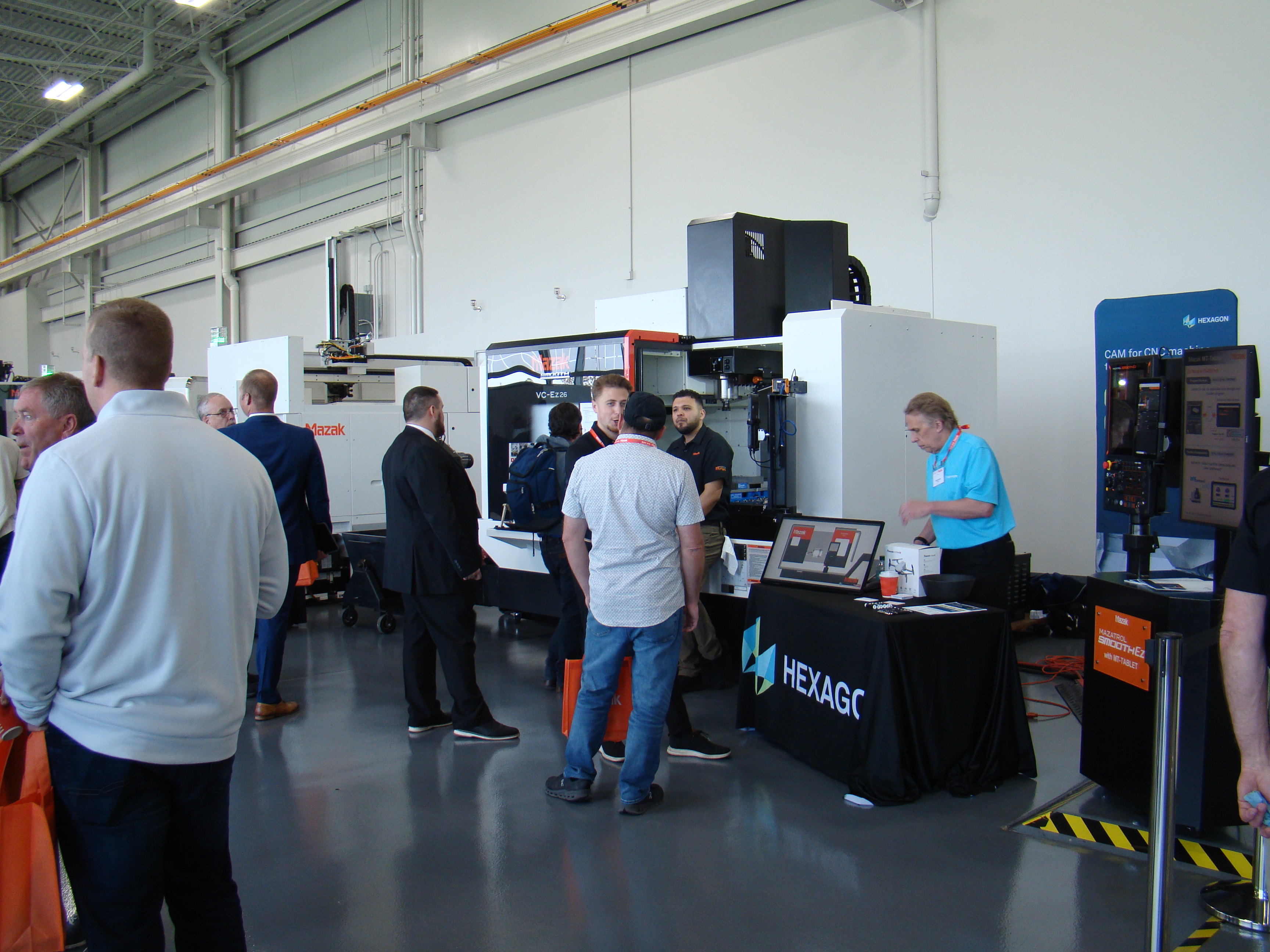 Attendees gather around CNC equipment and partner displays at Mazak’s Midwest Technology and Education Event.