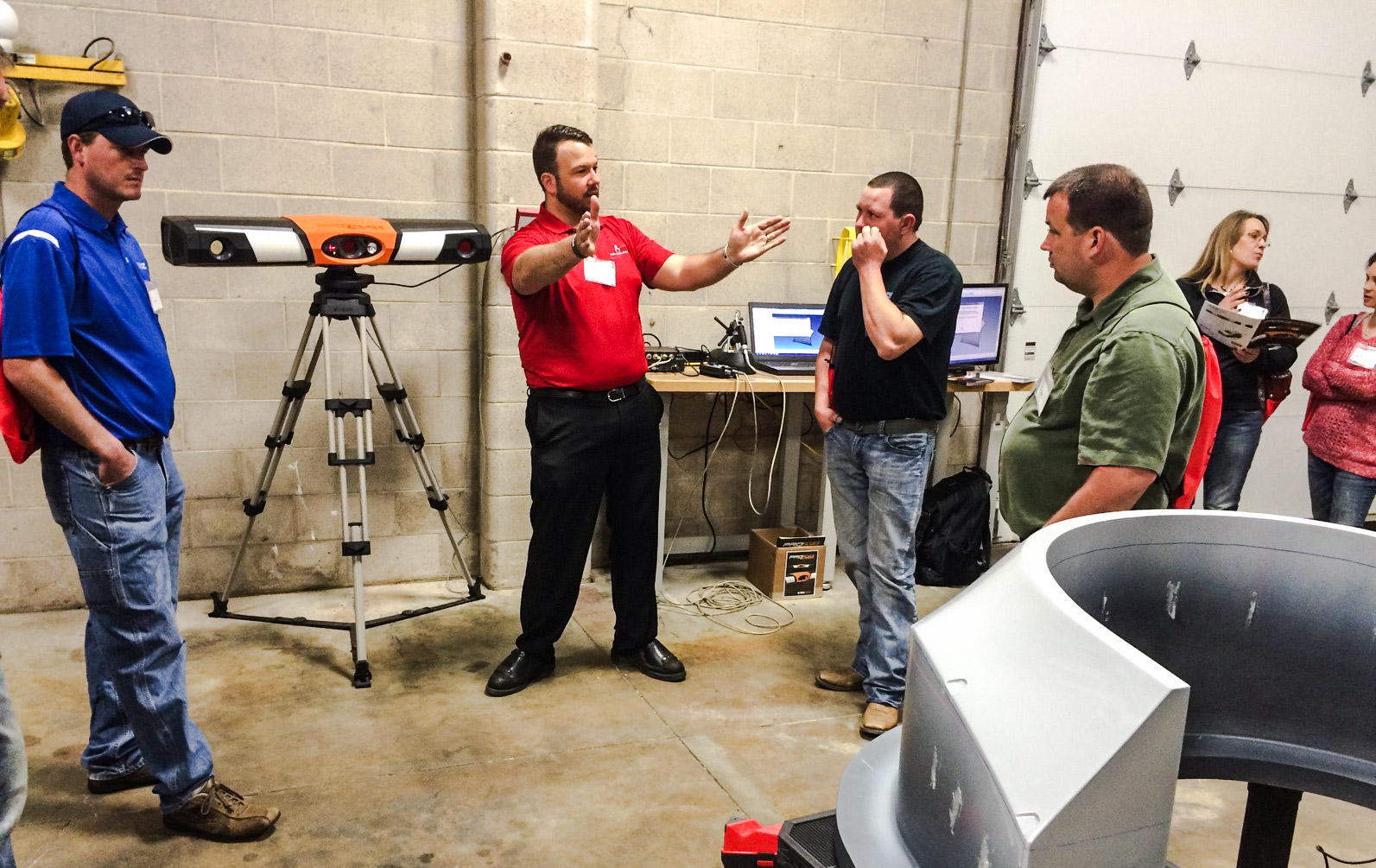 Exact Metrology personnel discussing the technology.