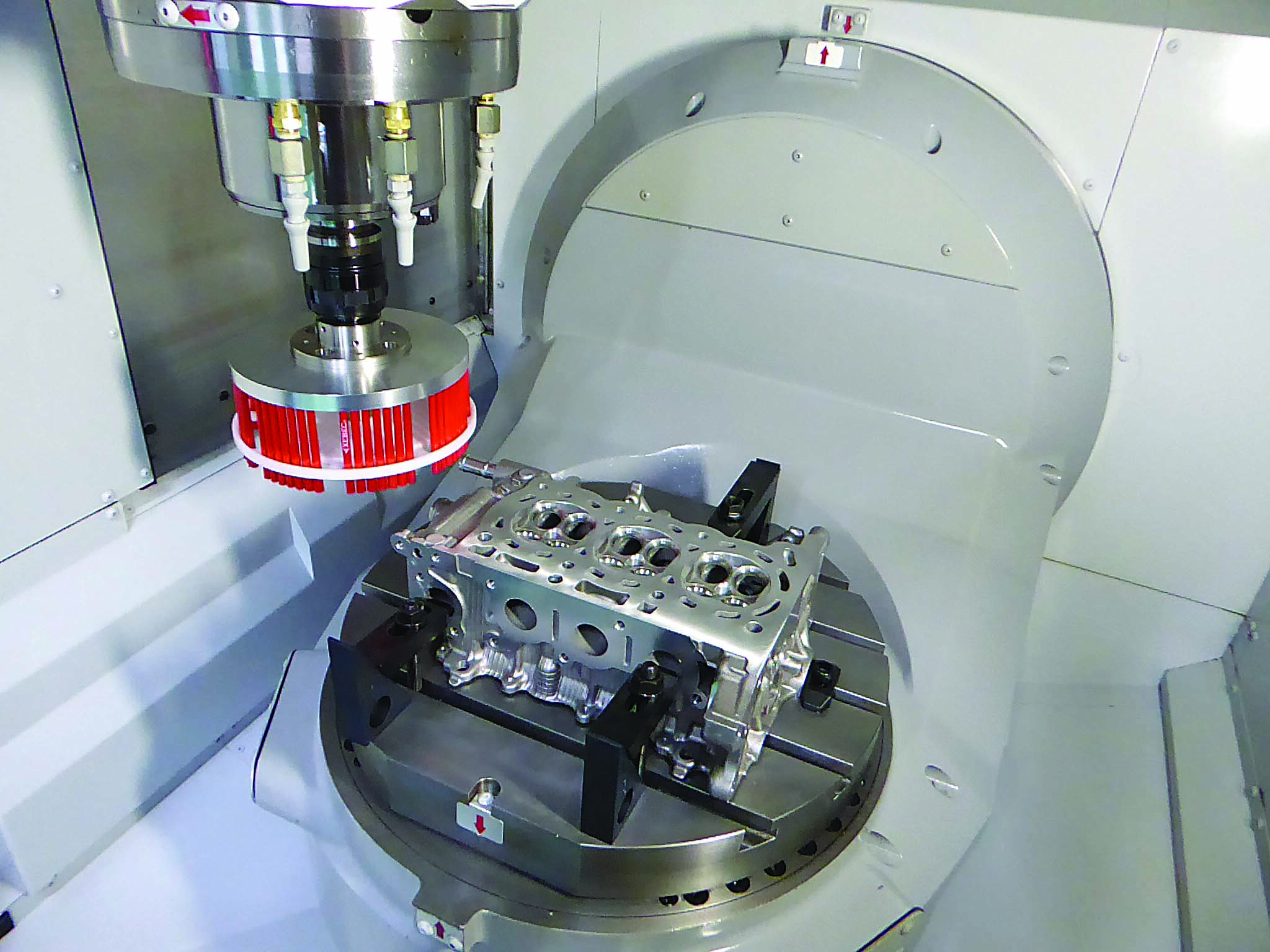 Automated surface deburring and finishing are performed on an engine block in a CNC using a ceramic fiber brush.