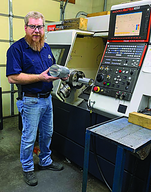 Jerry McNealy, owner and operator of Indian Mountain Machine Shop, displays thin-wall aluminum parts produced on a Mazak turning center with an STMD anti-vibration tool body from MAQ.