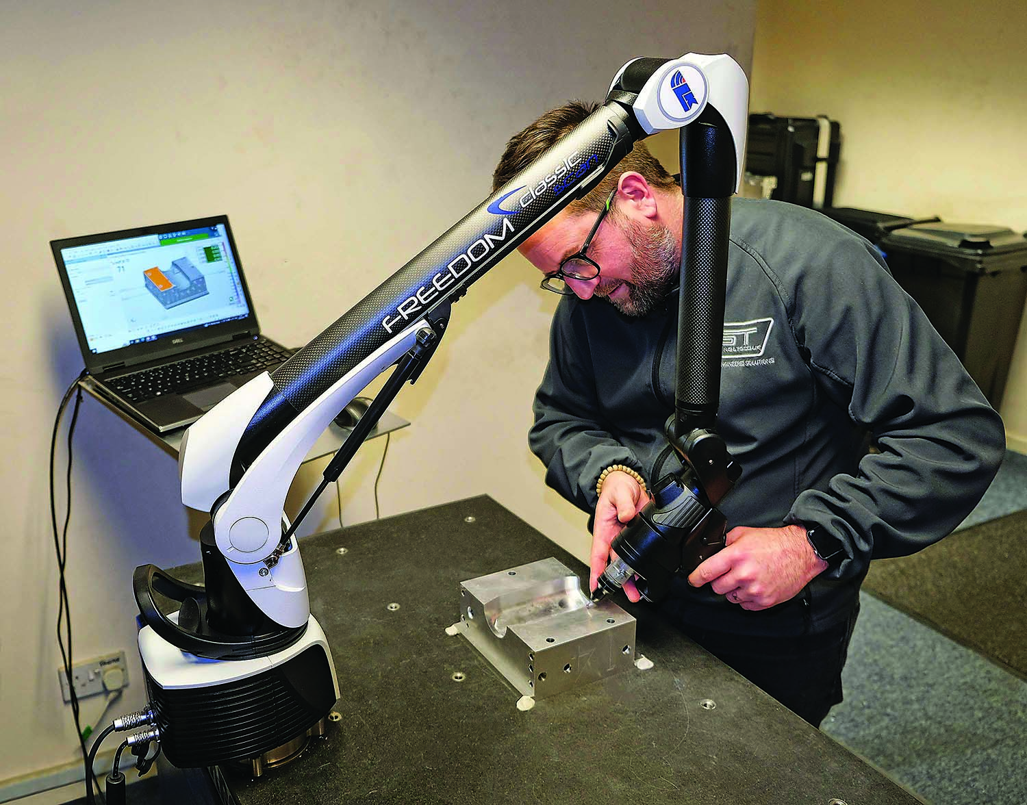 Ryan Leaves uses the Freedom Classic Scan portable arm at GT Tooling to inspect part of an aluminum extrusion blow mold for plastic bottle production.