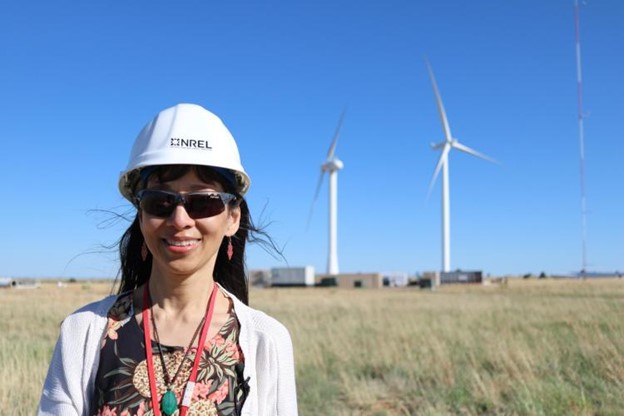 Lucy Pao stands at the National Renewable Energy Laboratory’s Flatirons campus with the 53.38-kW SUMR-D directly to her right.