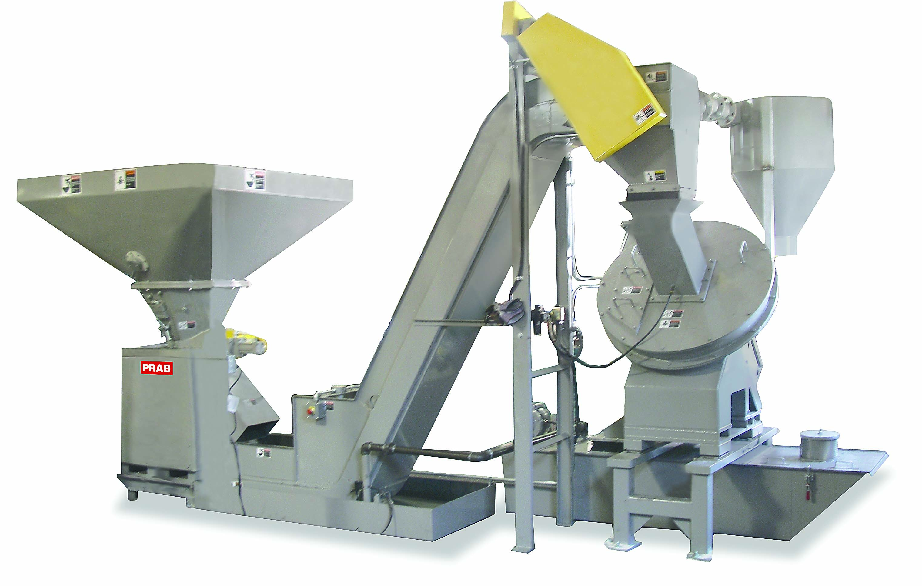 This chip handling system uses a crusher to reduce large bundles and stringy turnings before separating fluid from the chips with a wringer/centrifuge.