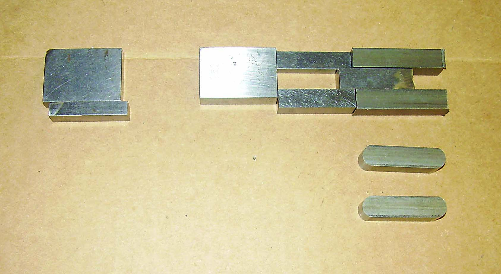 Displayed are the different gauge blocks with the key blanks out of the vise, along with a couple of finished keys.