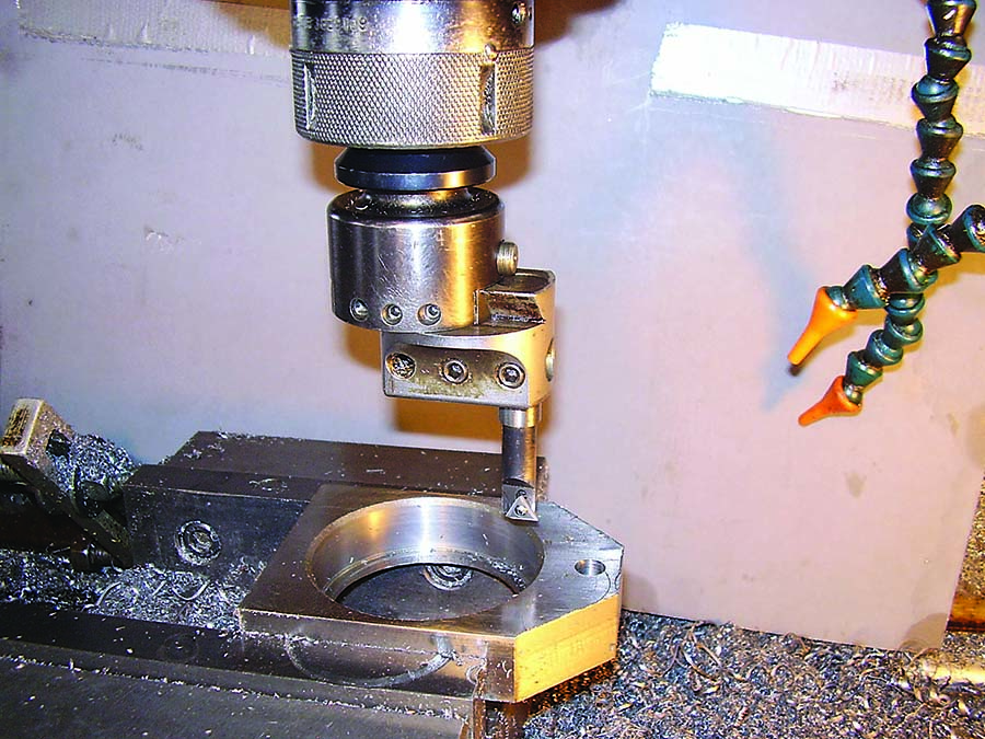 The part and the boring tool are on the milling machine.