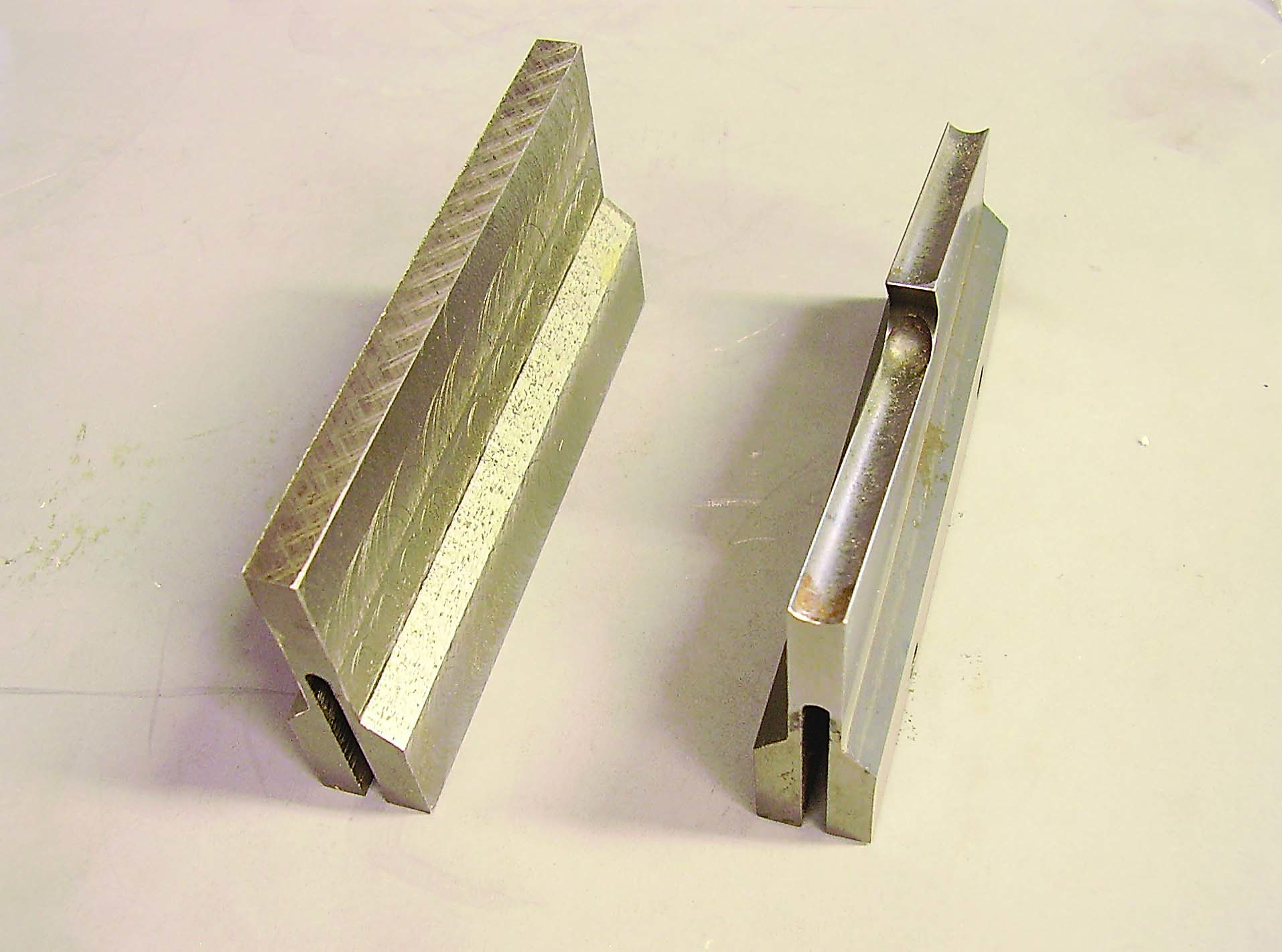 The part after slotting is displayed at left beside the finished part.