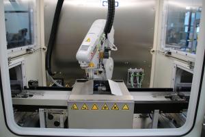 Workpiece carriers are loaded with around 150 parts are fed into and out of cleaning cabinets.