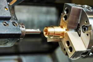 A brass part in a modern CNC machine tool. Credit: Shutterstock Inc.