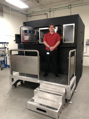 Zack Hopkins, Engineer II, Chromalloy Gas Turbine, with the company’s newly delivered Sapphire metal additive manufacturing system.