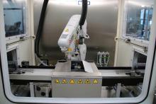Workpiece carriers are loaded with around 150 parts are fed into and out of cleaning cabinets.