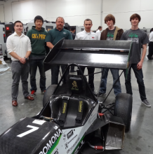 Cal Poly Pomona Engineering Students with Engineering Director Clifford Stover and SMTCL service technician Nathan LeMaster (3rd and 4th from the left) stand by one of the vehicles that Cal Poly Pomona will enter into competition. (Photo taken at SMTCL's Los Angeles Technical Center)