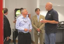 Discussing quality and workmanship on a MITGI facility tour. From left to right: Lee Miller (Hutchinson EDA), Deane Foote (President and CEO, Foote Consulting Group), Tim Ulrich (Hutchinson EDA Board President), Eric Lipke (General Manager, MITGI).
