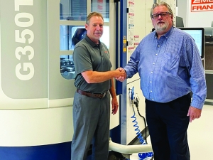 Emuge-Franken USA president Bob Hellinger (L) and Grob key account manager Kevin Gadde (R) share congratulatory wishes on their new partnership. Photo taken in front of the new Grob G350T 5-Axis mill-turn machine installed in the Emuge-Franken USA Technology Center in West Boylston, Massachusetts.