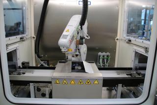 Workpiece carriers are loaded with around 150 parts are fed into and out of cleaning cabinets.