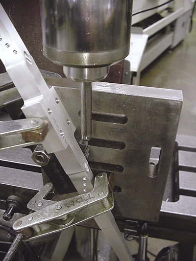 Holes that have to be machined at an extreme angle are cut into a tilted part on a conventional milling machine.