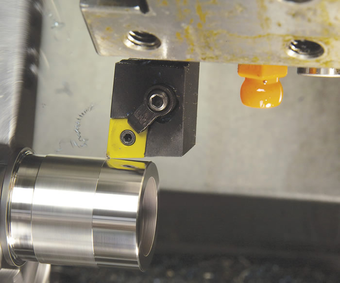 Turning with ceramic inserts is usually done dry. Here the toolholder is mounted face up, driving cutting forces down into the machine’s load-bearing surfaces.