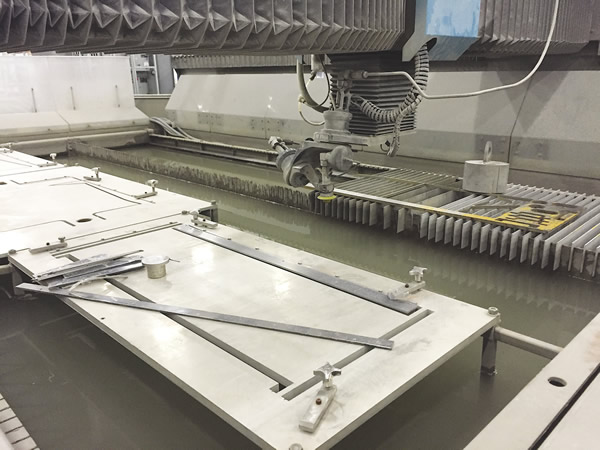 The use of dedicated fixtures on flatbed waterjet machines reduces opportunities for error and decreases setup times. These stainless steel fixtures are welded to the tank.