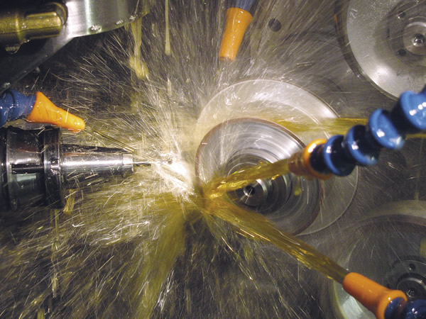 The inside of a CNC tool grinder is a busy place. Here, a small-diameter endmill is ground to size. Image courtesy Midwest Industrial Tool Grinding.