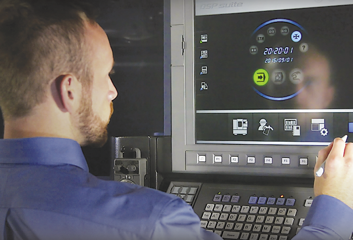 Brad Klippstein, Okuma applications engineer, demonstrates the company’s Advanced One-Touch programming system. Image courtesy Okuma America.