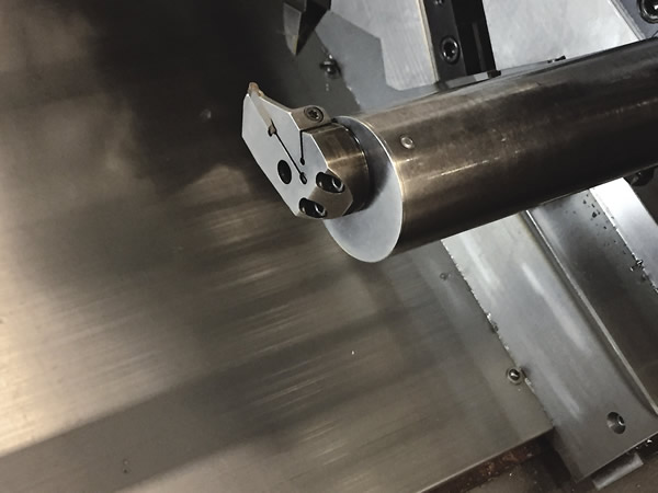 This boring bar for a lathe allows different cutting heads to be bolted on, so multiple styles of inserts can be applied. Image courtesy C. Tate.