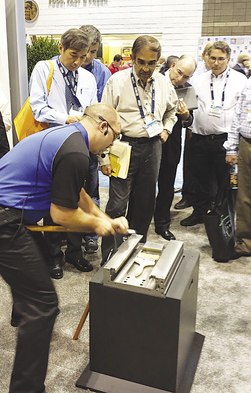 Robbie Williams conducts an in-booth hand scraping seminar at IMTS. Photo credit: Okuma America