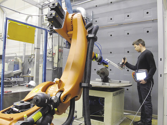 VTT says its wireless joystick controller makes programming continuous paths for a robot arm quick and easy. Image courtesy VTT Technical Research Centre of Finland.