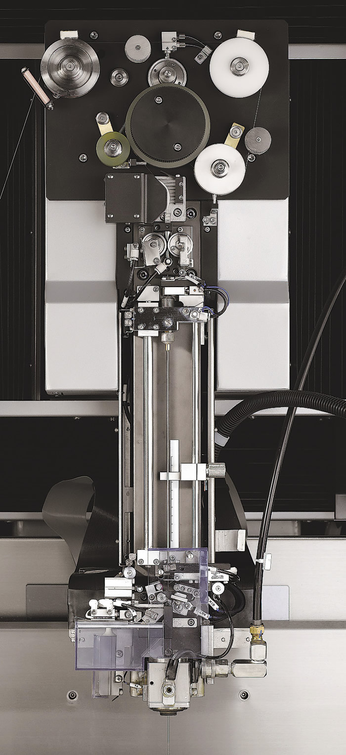 At top is the tortuous path a wire must take through an EDM. Below is Sodick’s formerly used tube mechanism for threading water-dielectric EDMs. Image courtesy Sodick.