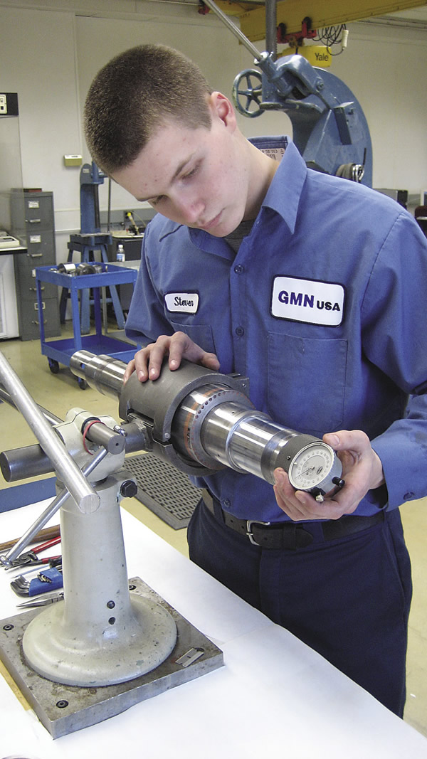 A technician checks the taper of a spindle shaft for size. Image courtesy GMN USA.