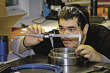 Juan Pacheco takes measurements as part of his operator training at LeanWerks. Image courtesy LeanWerks.