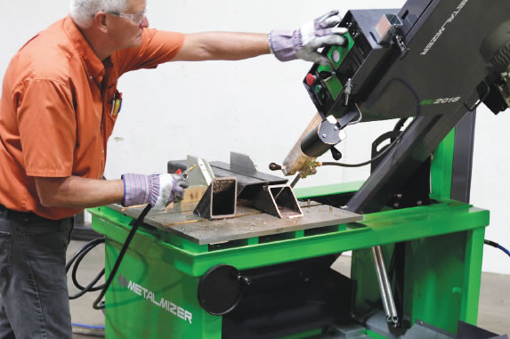 A user checks the angle controls on a MetalMizer vertical bandsaw. Image courtesy Wood-Mizer.