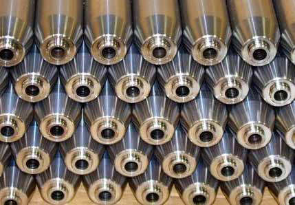 Gun barrels at the beginning stages of production, prior to being hammer forged.