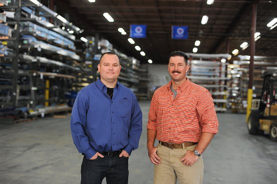 Thomas DeSaulniers (left), branch manager of T&C Metals, with United States Coast Guard veteran Justin Wood at T&C's Jacksonville warehouse. 