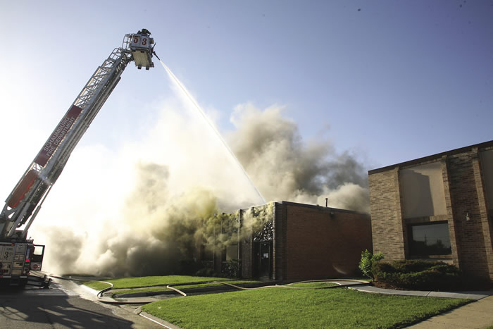Firefighters work to extinguish a fire at Taurus Tool’s previous facility in Schaumburg, Ill.