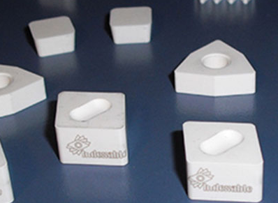 White ceramic inserts for cast iron and high-temperature alloys.