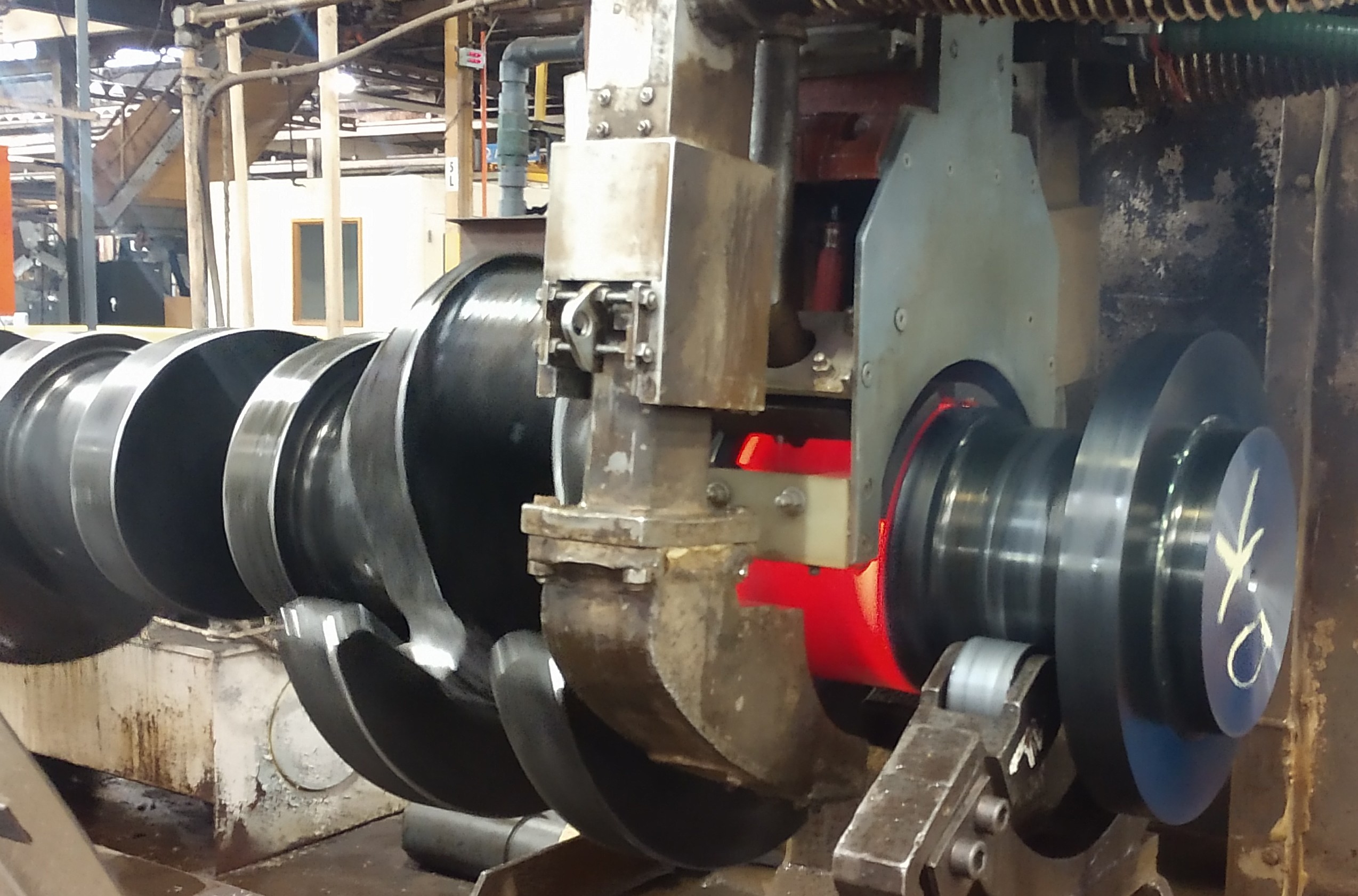 Locomotion crankshaft being induction hardened.