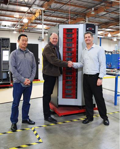 Steve Pixley, at center, unveils his 1,000th RoboCrib VX1000 machine alongside original AutoCrib business partners Jonathan Kim, chief technology officer for AutoCrib, at left, and Bruce Weaver, currently of US Tool Group.
