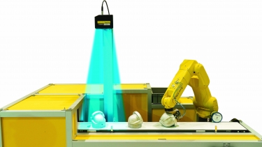 A FANUC LR Mate 200iD uses 3D vision for part orientation. Image courtesy of FANUC America.