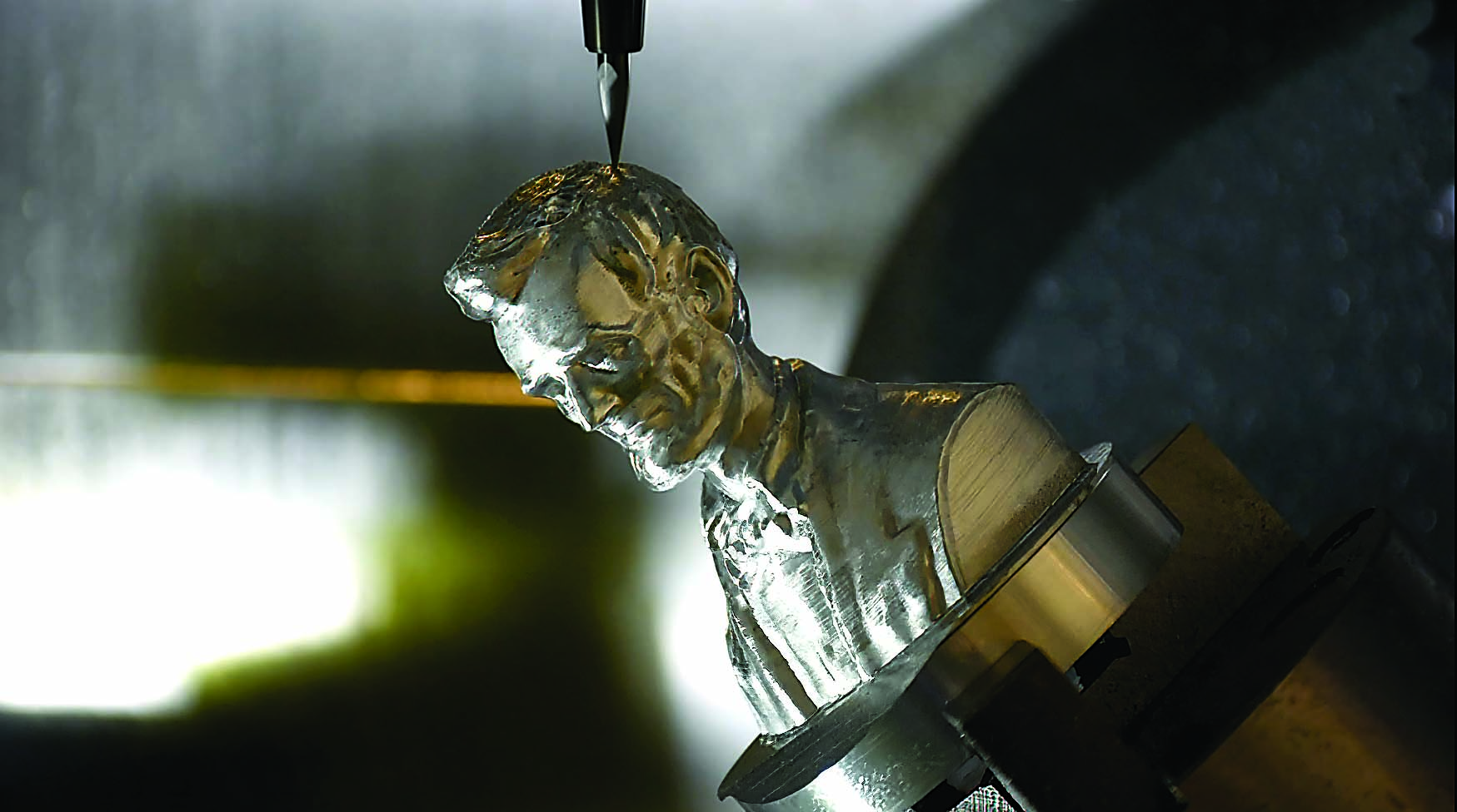 The resulting part shows the bust of Abraham Lincoln after machining using Mastercam's mesh editing and toolpaths.