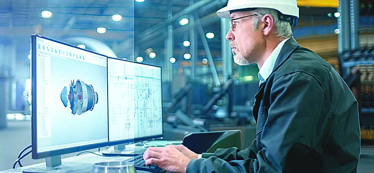 Chief Engineer Jerry Halley gathers information from Tech Manufacturing's CNC monitoring system.